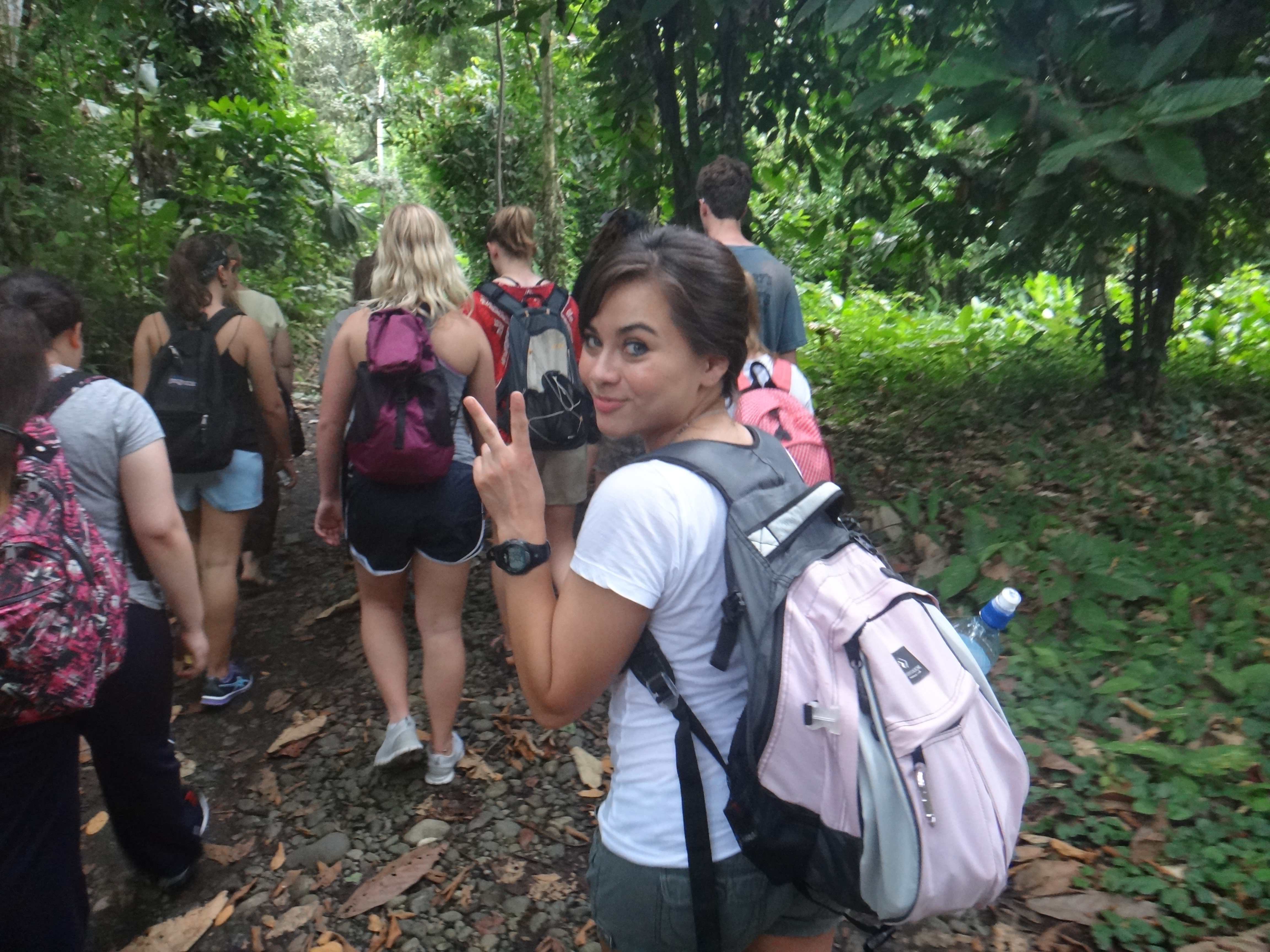 Tahiri and volunteers trekking through the cocoa forest.